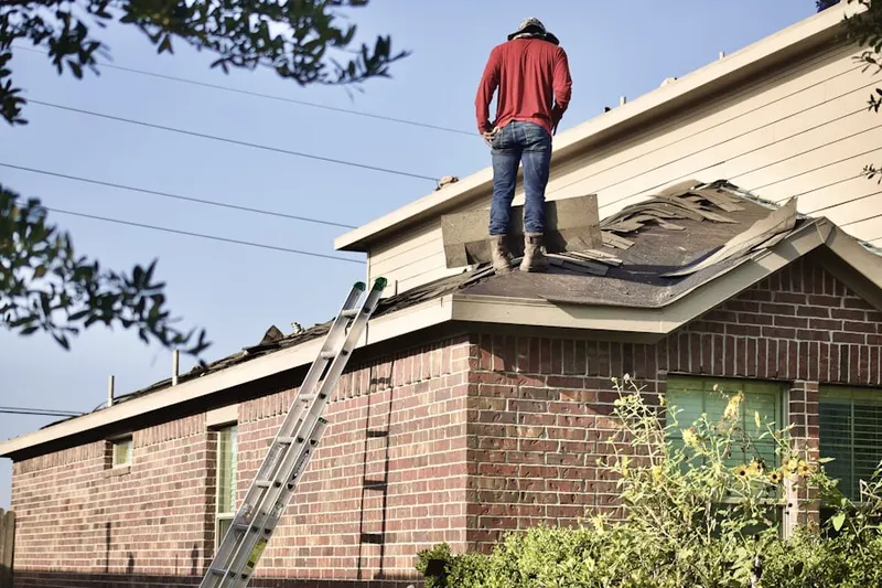 Professional roofer working on a residential roof in Wading River